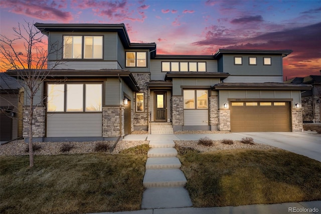 prairie-style home featuring an attached garage, stone siding, and driveway