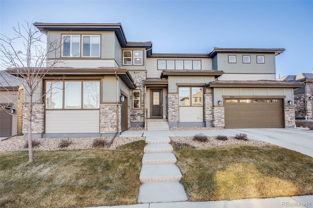 prairie-style home with a garage, stone siding, and concrete driveway