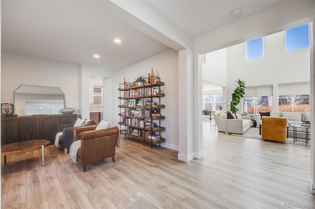 sitting room with light wood finished floors, baseboards, and recessed lighting