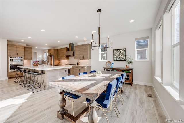 dining area with light wood-style flooring, visible vents, baseboards, and recessed lighting