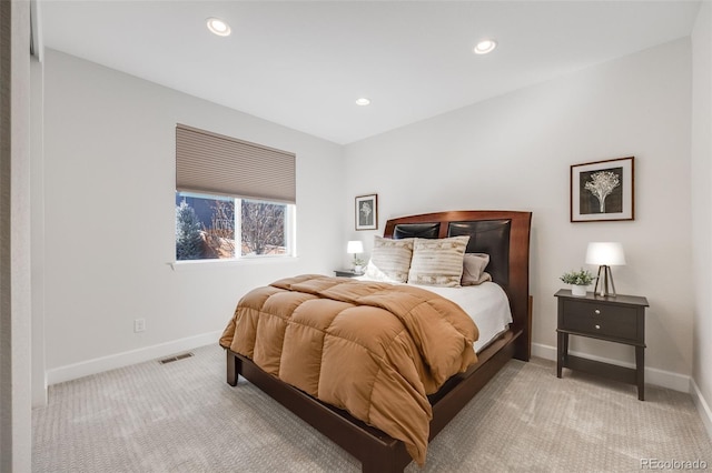 bedroom featuring recessed lighting, light colored carpet, visible vents, and baseboards