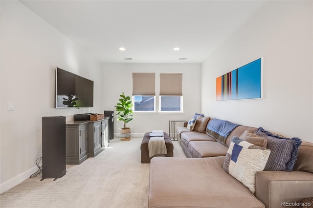 living room featuring recessed lighting, baseboards, and light colored carpet