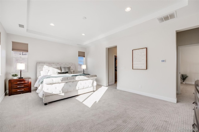 bedroom with recessed lighting, light colored carpet, visible vents, baseboards, and a raised ceiling