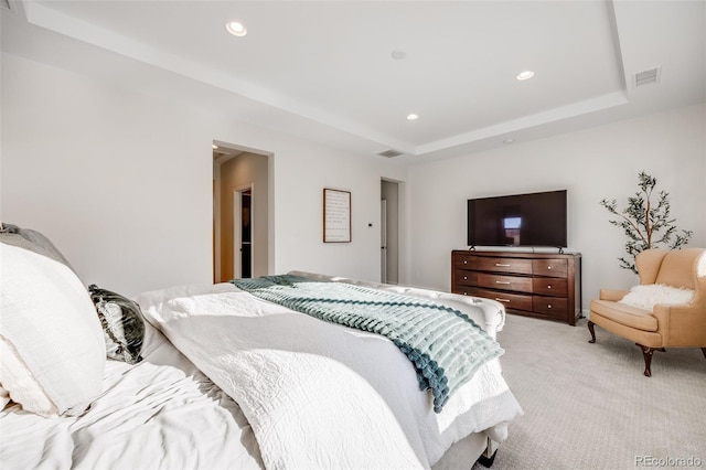 bedroom with recessed lighting, visible vents, a raised ceiling, and light colored carpet