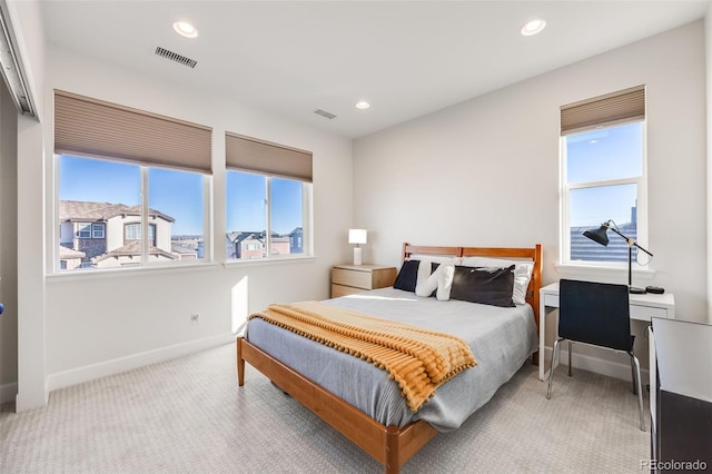 carpeted bedroom with multiple windows, visible vents, and recessed lighting