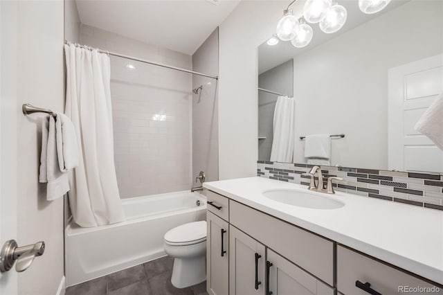 bathroom featuring tasteful backsplash, shower / bath combination with curtain, toilet, vanity, and tile patterned floors