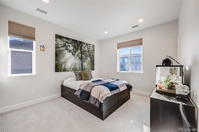 carpeted bedroom featuring baseboards, visible vents, and recessed lighting