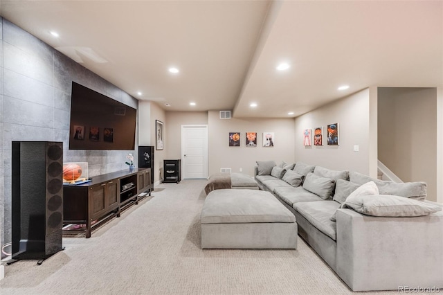 living area with recessed lighting, visible vents, and light colored carpet