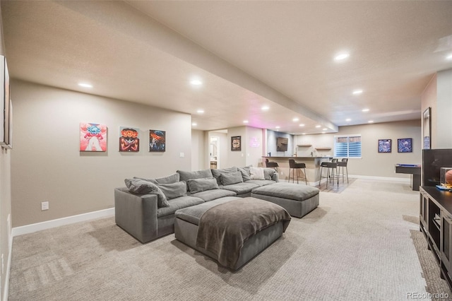 living room with recessed lighting, baseboards, and light colored carpet