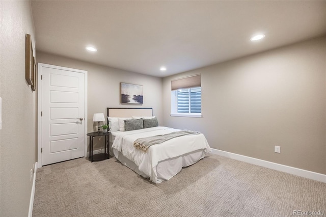 bedroom featuring recessed lighting, light colored carpet, and baseboards