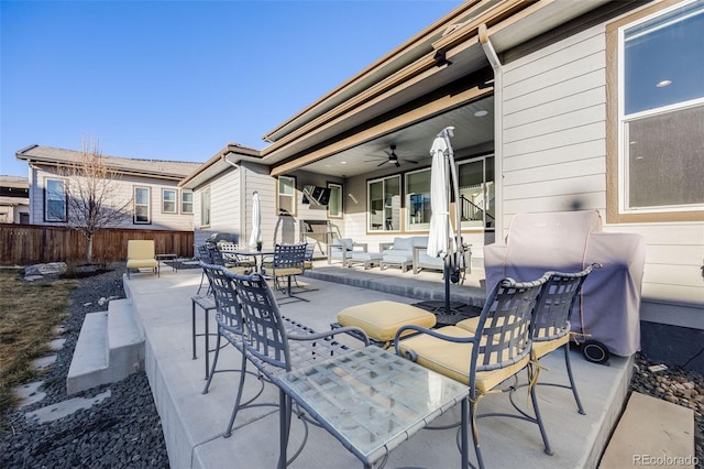 view of patio / terrace featuring fence, outdoor dining area, and a ceiling fan