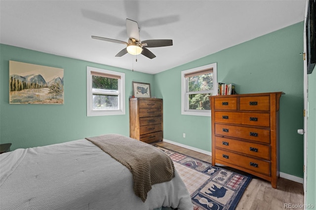 5211 Parmalee Gulch Rd, Indian Hills, CO 80454 - bedroom with multiple windows, light wood-type flooring, and ceiling fan
