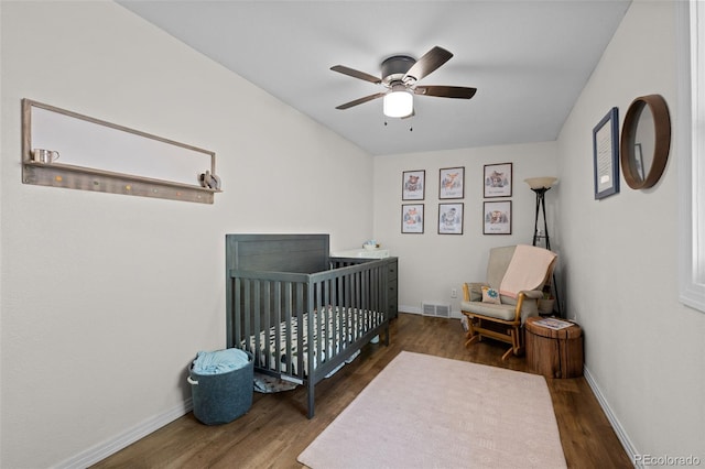 5211 Parmalee Gulch Rd, Indian Hills, CO 80454 - bedroom with wood finished floors, a nursery area, and a ceiling fan