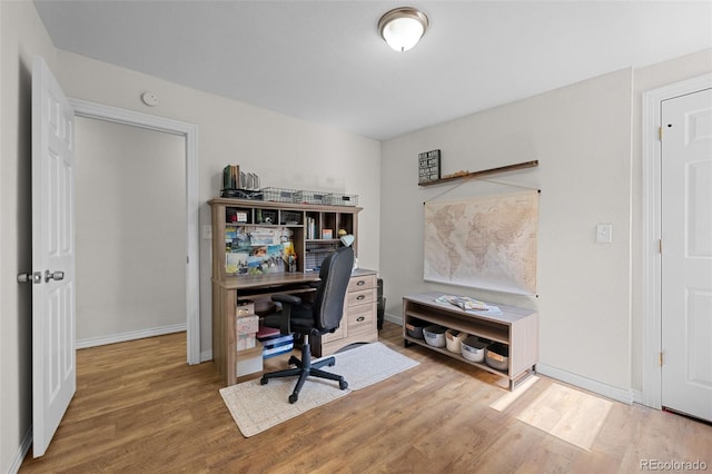 5211 Parmalee Gulch Rd, Indian Hills, CO 80454 - office area featuring wood finished floors and baseboards