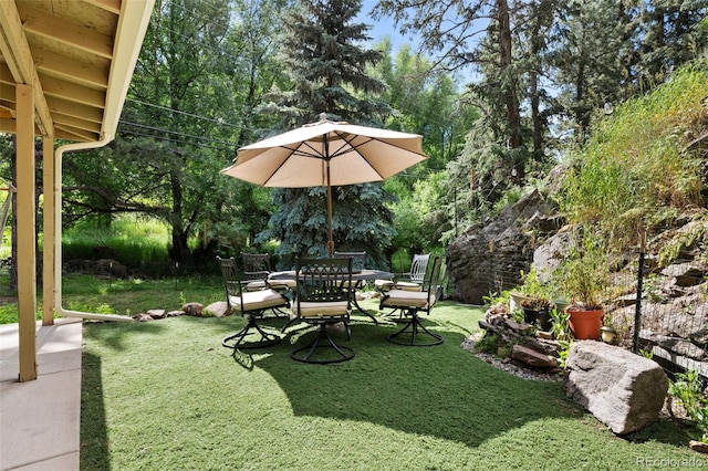 5211 Parmalee Gulch Rd, Indian Hills, CO 80454 - view of grassy yard with outdoor dining space