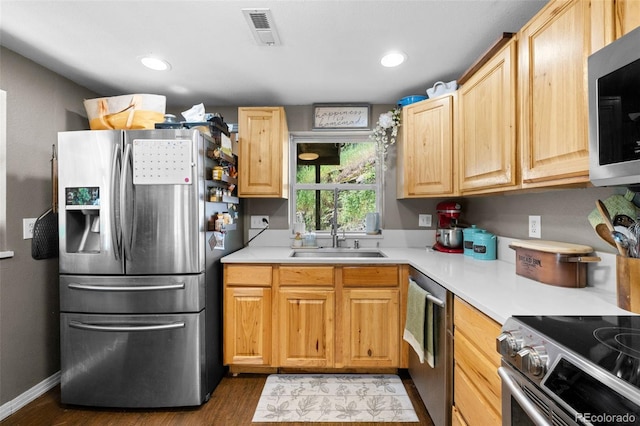 5211 Parmalee Gulch Rd, Indian Hills, CO 80454 - kitchen featuring stainless steel appliances, wood finished floors, light countertops, light brown cabinets, and recessed lighting