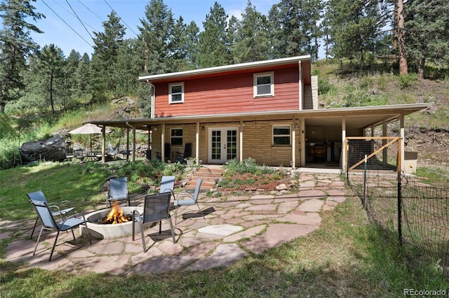 5211 Parmalee Gulch Rd, Indian Hills, CO 80454 - back of property featuring french doors, a fire pit, and a patio
