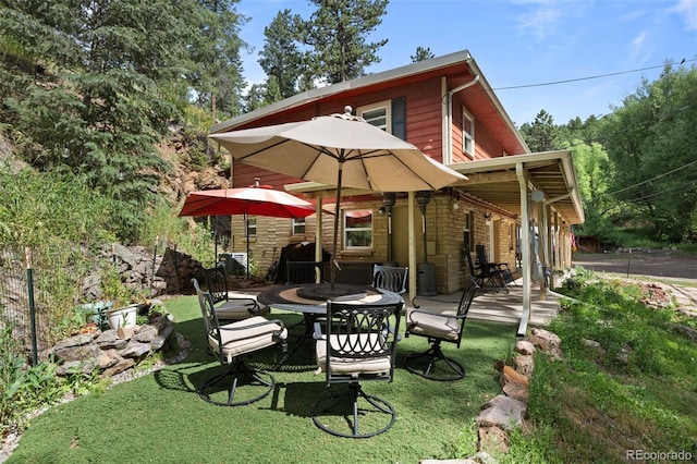 5211 Parmalee Gulch Rd, Indian Hills, CO 80454 - rear view of property featuring an outdoor fire pit, a yard, and a patio area