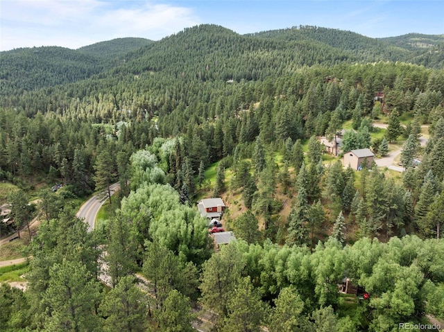 5211 Parmalee Gulch Rd, Indian Hills, CO 80454 - aerial view of property and surrounding area featuring a heavily wooded area and mountains