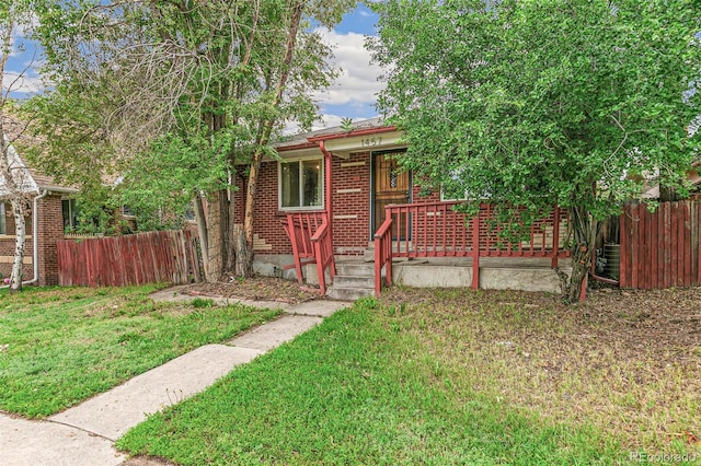 1457 S Franklin St, Denver, CO 80210 - view of front facade featuring brick siding and a porch