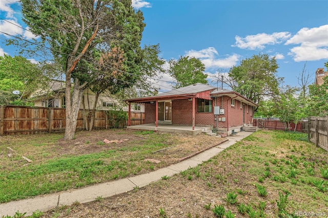 1457 S Franklin St, Denver, CO 80210 - back of property with brick siding and a patio area