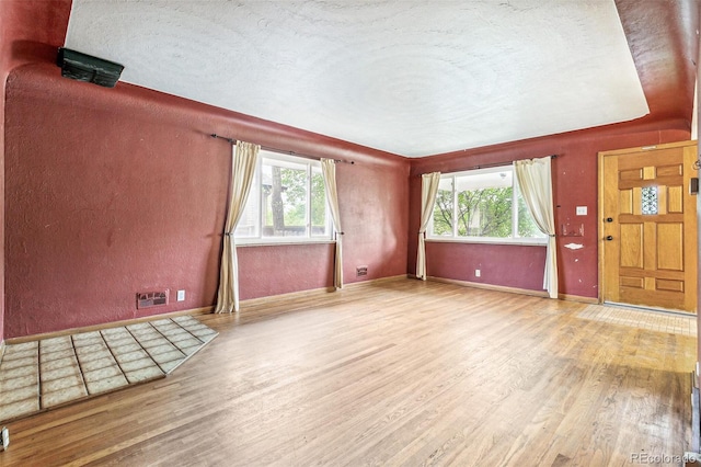 1457 S Franklin St, Denver, CO 80210 - spare room with wood finished floors, baseboards, and a textured ceiling