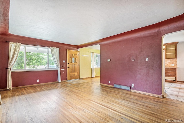 1457 S Franklin St, Denver, CO 80210 - unfurnished living room featuring light wood-type flooring and plenty of natural light