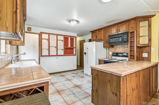 1457 S Franklin St, Denver, CO 80210 - kitchen with black microwave, range with electric stovetop, a sink, tile counters, and tasteful backsplash
