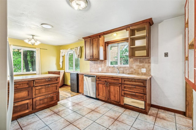 1457 S Franklin St, Denver, CO 80210 - kitchen with dishwasher, tile counters, a sink, brown cabinets, and tasteful backsplash
