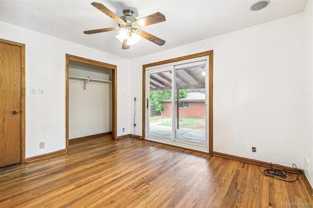 1457 S Franklin St, Denver, CO 80210 - unfurnished bedroom with access to exterior, light wood-type flooring, baseboards, and a ceiling fan