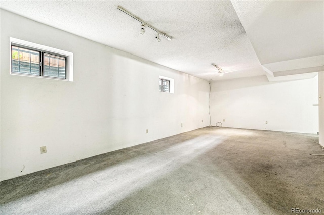 1457 S Franklin St, Denver, CO 80210 - spare room featuring track lighting, carpet floors, and a textured ceiling