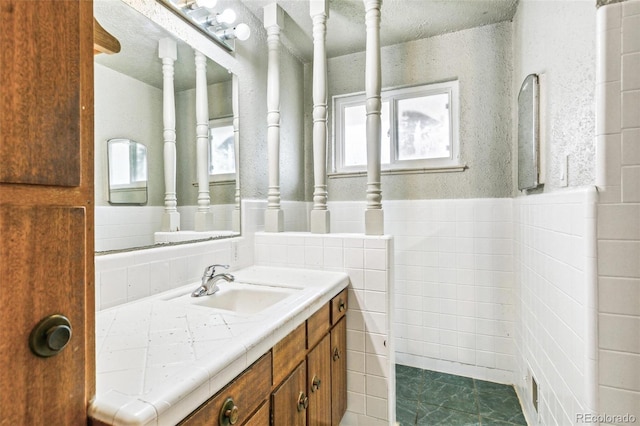 1457 S Franklin St, Denver, CO 80210 - bathroom with vanity, healthy amount of natural light, wainscoting, and tile walls