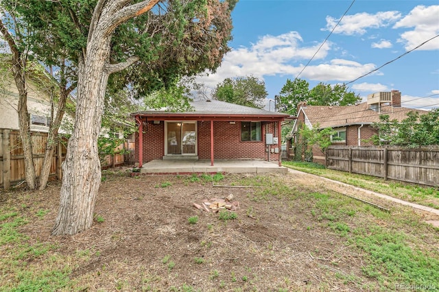 1457 S Franklin St, Denver, CO 80210 - rear view of property featuring brick siding, a patio area, and a fenced backyard
