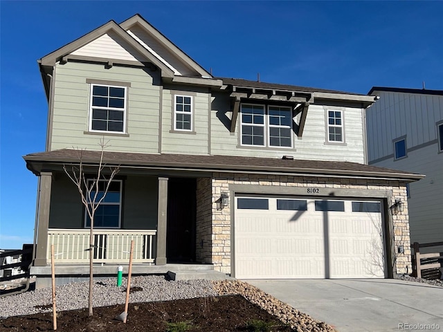 view of front of home featuring a porch and a garage