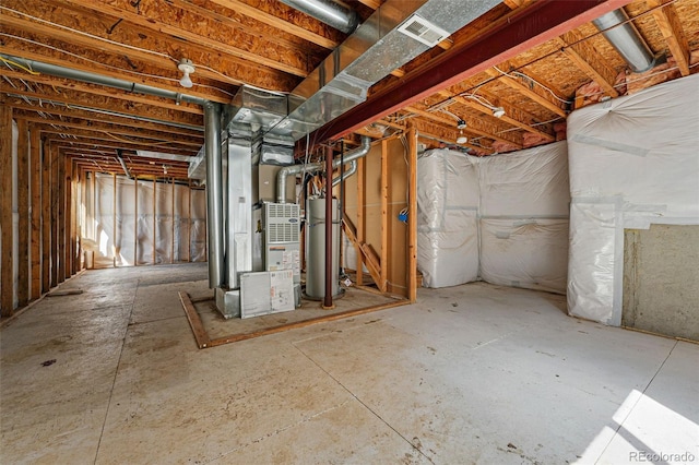below grade area featuring visible vents, heating unit, and gas water heater