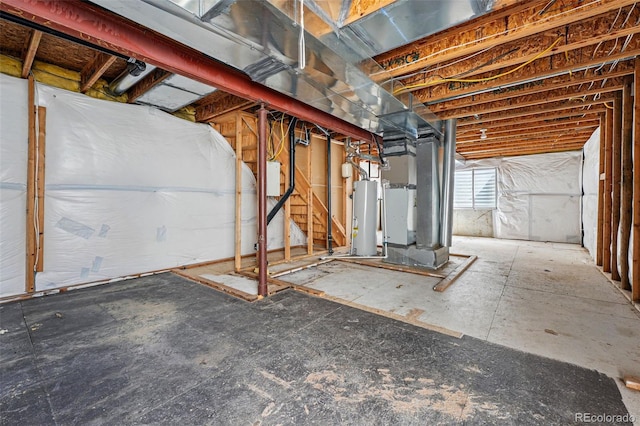 basement featuring heating unit and water heater