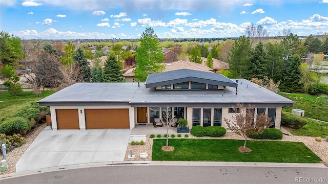 6 Wilder Ln, Littleton, CO 80123 - view of front of property with an attached garage, concrete driveway, and a front lawn