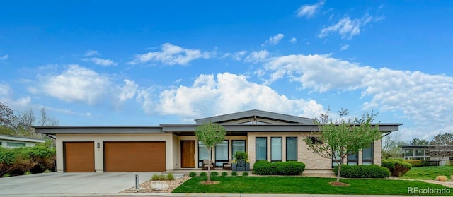 6 Wilder Ln, Littleton, CO 80123 - view of front of house featuring a garage, a front yard, and concrete driveway