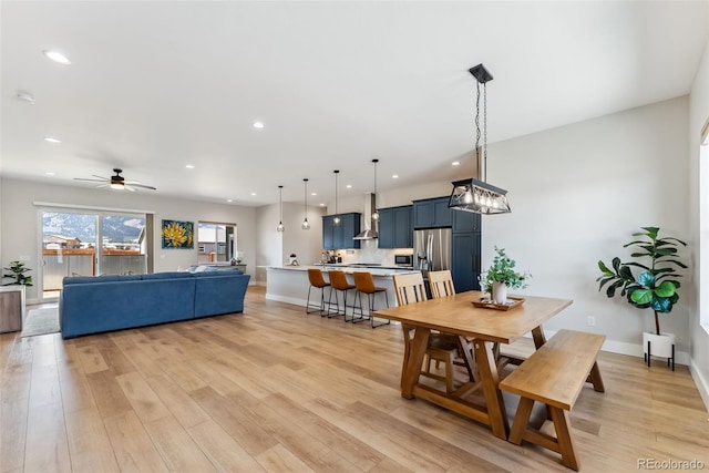 dining space featuring recessed lighting and light wood-style flooring