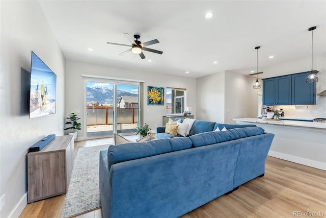 living room featuring recessed lighting, ceiling fan, and light wood-type flooring