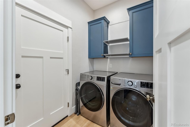 clothes washing area with light wood-style floors, cabinet space, and independent washer and dryer