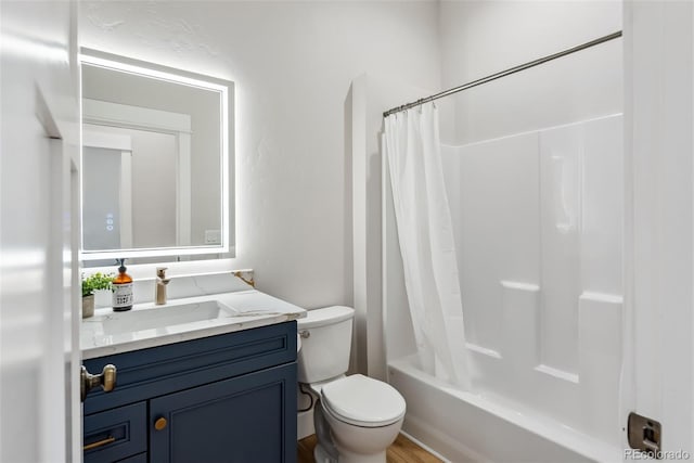 bathroom featuring vanity, shower / bath combo with shower curtain, and toilet
