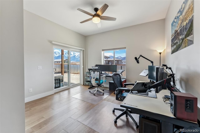office area featuring baseboards, a ceiling fan, and wood finished floors