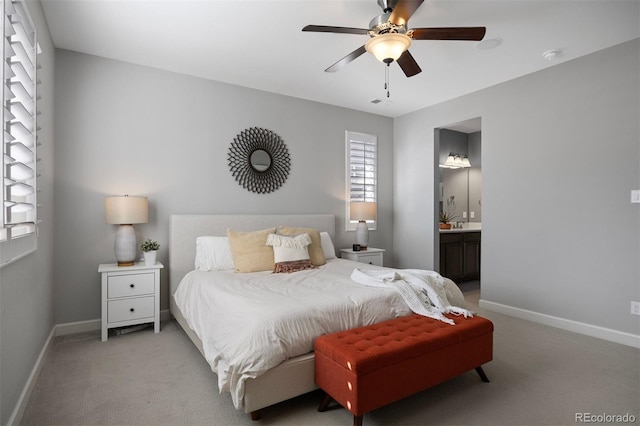 bedroom with light carpet, ceiling fan, and ensuite bathroom