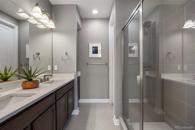 bathroom with vanity, tile patterned flooring, and a shower with door