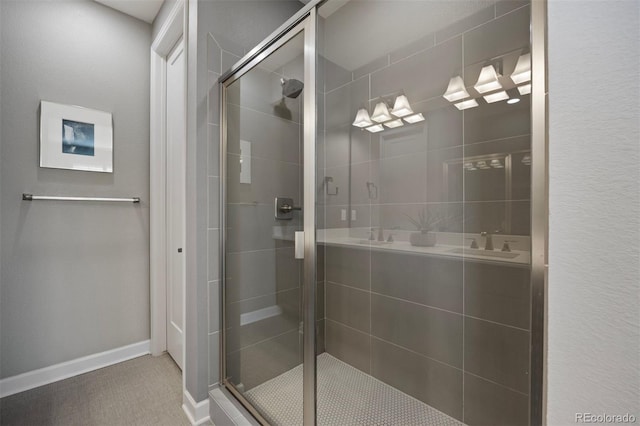 bathroom featuring a shower with shower door