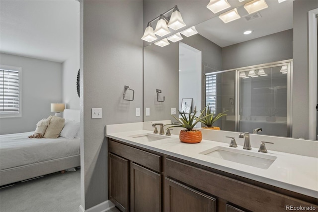 bathroom with vanity and a shower with door