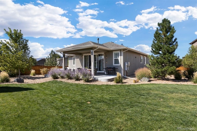 rear view of property with a patio area and a lawn