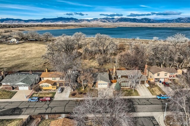 birds eye view of property featuring a water and mountain view
