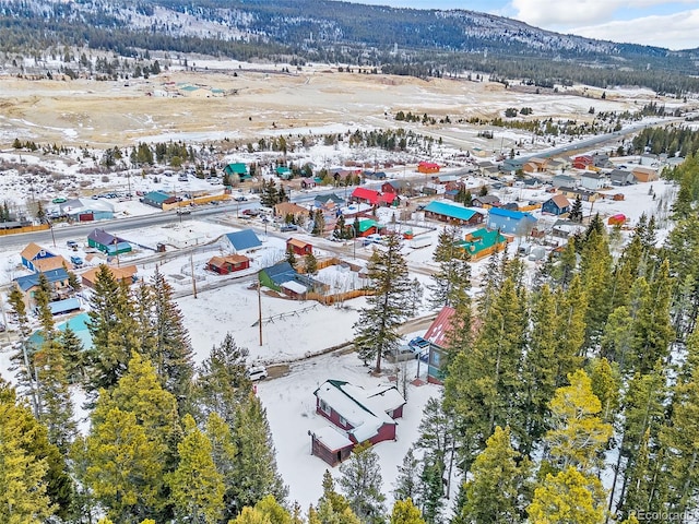 snowy aerial view with a mountain view